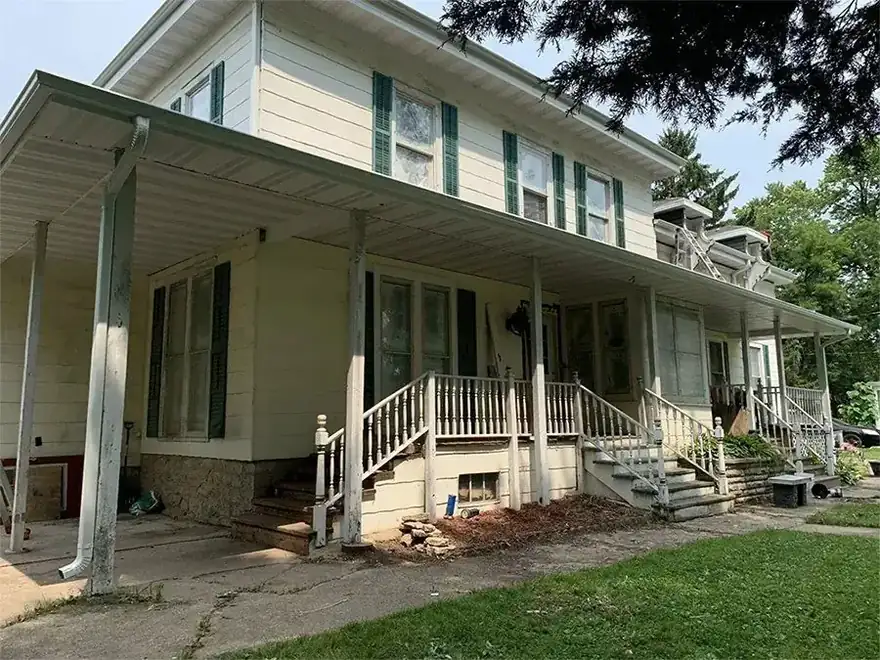 Two storey farmhouse with a covered front porch